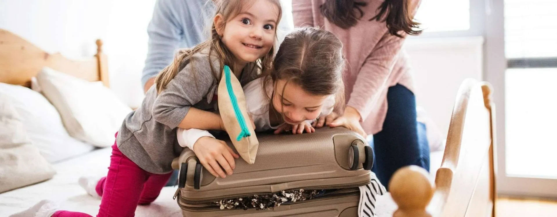 Famille avec deux enfants préparant les valises pour un voyage en famille
