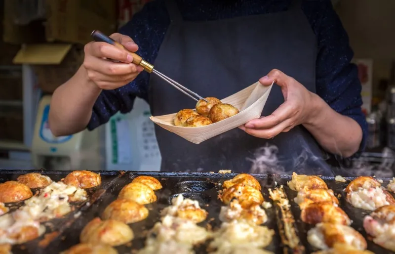 Un chef préparant des takoyaki à Osaka