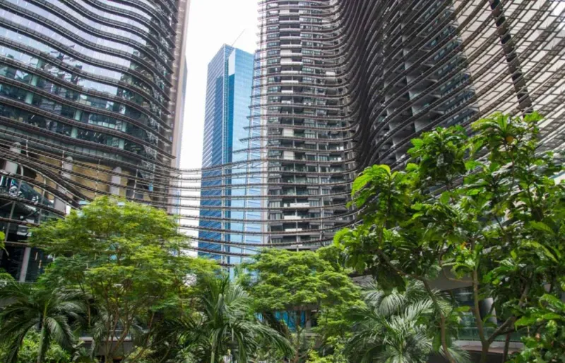 Gratte-ciel modernes à Singapour entourés de végétation illustrant son développement économique et urbain