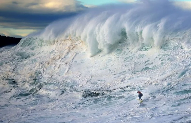 Surfeur face à une vague géante de Belharra au Pays basque, célèbre spot de surf de grosses vagues en France