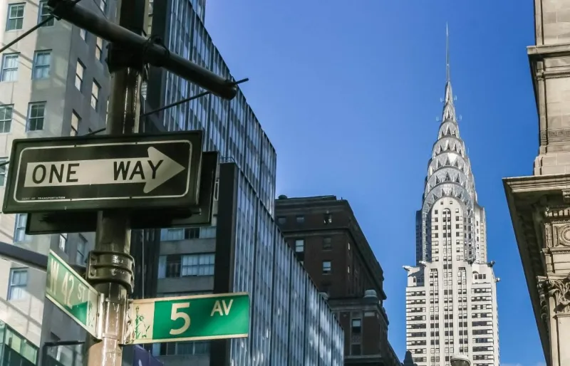 Chrysler Building à New York photographié depuis une rue de Manhattan avec des panneaux de signalisation au premier plan