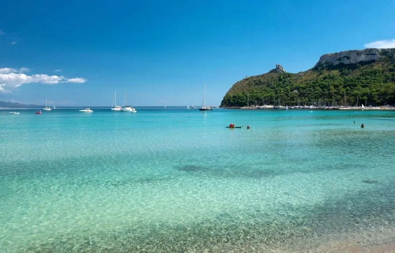 Eaux turquoise de la plage du Poetto avec la Sella del Diavolo en arrière-plan à Cagliari