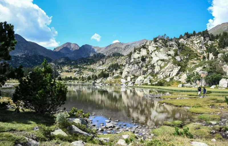 Randonneurs au bord du lac des Bouillouses sur la boucle des 9 étangs dans les Pyrénées-Orientales